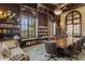 Library with large bookshelves, coffered ceiling, and a long table for reading or meetings at 20126 Elegante Ct, Venice, FL 34293