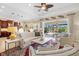 Open living room with high ceilings, fan, modern furniture, and access to screened-in lanai and pool at 20126 Elegante Ct, Venice, FL 34293