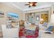 Open concept living room with elegant furnishings, TV, and access to other areas of the home at 20126 Elegante Ct, Venice, FL 34293