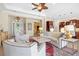 Open-concept living room with neutral decor, large area rug, and easy access to the kitchen at 20126 Elegante Ct, Venice, FL 34293