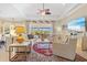 Open living room with high ceilings, fan, modern furniture, and access to the lanai at 20126 Elegante Ct, Venice, FL 34293