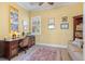 Home office featuring an ornate desk, woven chair, and view of backyard at 20126 Elegante Ct, Venice, FL 34293