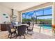 Outdoor kitchen and dining area with built-in grill and seating at 20126 Elegante Ct, Venice, FL 34293