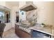 Outdoor kitchen with built-in grill, marble countertops, and stainless steel appliances at 20126 Elegante Ct, Venice, FL 34293