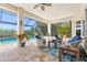 Outdoor living area with comfortable seating, ceiling fan, and serene pool views at 20126 Elegante Ct, Venice, FL 34293