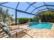 Inviting screened-in pool area with lounge chairs at 20126 Elegante Ct, Venice, FL 34293