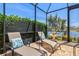 Screened-in patio with lounge chairs and fountain at 20126 Elegante Ct, Venice, FL 34293
