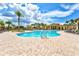 Large swimming pool with lounge chairs, palm trees, and beautiful resort-style amenities at 20126 Elegante Ct, Venice, FL 34293