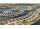 Aerial view of homes nestled along a waterfront community with lakes at 20188 Tesoro Dr, Venice, FL 34293