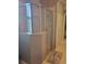 Bathroom with tiled shower featuring glass doors and a closet at 20188 Tesoro Dr, Venice, FL 34293
