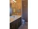 Bathroom featuring double sinks, dark wood cabinets and tiled floors at 20188 Tesoro Dr, Venice, FL 34293