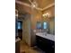 Elegant bathroom with a dual sink vanity, decorative lighting, and ample storage space at 20188 Tesoro Dr, Venice, FL 34293