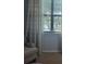 Bedroom seating area showcasing a window with scenic views and stylish curtains at 20188 Tesoro Dr, Venice, FL 34293