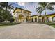 Community clubhouse entrance with yellow and white facade at 20188 Tesoro Dr, Venice, FL 34293