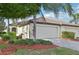 Charming single-story home featuring a tile roof, two-car garage, and beautifully landscaped front yard at 20188 Tesoro Dr, Venice, FL 34293