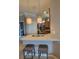 Kitchen bar with seating area, stainless steel appliances and hanging pendant lights at 20188 Tesoro Dr, Venice, FL 34293