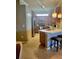 Well-lit kitchen with stainless steel appliances, wooden cabinetry, and a breakfast bar with seating at 20188 Tesoro Dr, Venice, FL 34293