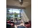 Covered lanai with stylish outdoor seating with lake views, perfect for relaxing or entertaining at 20188 Tesoro Dr, Venice, FL 34293