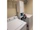 Functional laundry room equipped with a washer, dryer, storage shelves, and a tall storage cabinet at 20188 Tesoro Dr, Venice, FL 34293