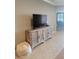 Living room featuring tile flooring and a decorative cabinet with a flat screen TV at 20188 Tesoro Dr, Venice, FL 34293