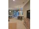 Open-concept home featuring living area with bar seating at the kitchen counter, adjacent to the dining area at 20188 Tesoro Dr, Venice, FL 34293