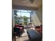 Inviting screened-in patio with comfortable seating, ceiling fan, and serene lake views for relaxing outdoor living at 20188 Tesoro Dr, Venice, FL 34293