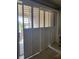 Sliding glass doors with stylish shutters that provide natural light and access to outdoor living space at 20188 Tesoro Dr, Venice, FL 34293