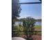 Picturesque lake view from the screened-in patio, featuring lush greenery and tranquil water at 20188 Tesoro Dr, Venice, FL 34293