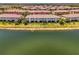 Aerial view of townhomes with well-manicured lawns and lakefront setting at 20237 Lagente Cir, Venice, FL 34293
