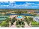 Aerial view of community showcasing a lake, tennis courts, pool, and beautiful clubhouse at 20237 Lagente Cir, Venice, FL 34293