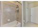 Bathroom featuring a bathtub, shower, and tiled walls at 20237 Lagente Cir, Venice, FL 34293