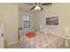 Bedroom with coral themed bedspread, neutral paint, and plenty of sunlight at 20237 Lagente Cir, Venice, FL 34293