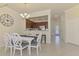 Bright dining area with a contemporary table, stylish chairs, and a view of the open kitchen at 20237 Lagente Cir, Venice, FL 34293