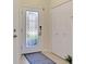 Bright foyer with tile floors, a glass-paneled door, and a convenient closet for storage at 20237 Lagente Cir, Venice, FL 34293