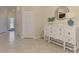 Light and airy foyer with stylish white dresser and decorative mirror at 20237 Lagente Cir, Venice, FL 34293