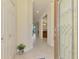 Bright and airy foyer with tile flooring, elegant door, and a view into the dining and kitchen areas at 20237 Lagente Cir, Venice, FL 34293