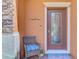 Inviting front entrance with stylish door, welcome sign, and cozy chair, creating a warm ambiance at 20237 Lagente Cir, Venice, FL 34293