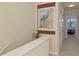 Hallway with neutral paint and views of a bedroom with ceiling fan at 20237 Lagente Cir, Venice, FL 34293