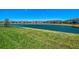 Scenic view of the lake surrounded by green grass and townhomes at 20237 Lagente Cir, Venice, FL 34293
