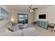 Bright living room showcasing a comfortable sectional, TV, and lake views at 20237 Lagente Cir, Venice, FL 34293
