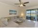 Comfortable living room with plush sectional sofa and views of the lake at 20237 Lagente Cir, Venice, FL 34293