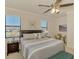 Bedroom featuring a ceiling fan, carpet, and large window at 20237 Lagente Cir, Venice, FL 34293