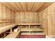 This home features a beautiful sauna with wooden benches and walls, offering a relaxing spa-like experience at 20237 Lagente Cir, Venice, FL 34293