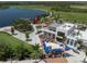 Aerial view of commercial and recreational area with restaurants, green space, and lake views at 20285 Symphony Pl, Venice, FL 34293
