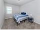 Cozy bedroom with carpeted floors, a twin bed, and a window with bright natural light at 20285 Symphony Pl, Venice, FL 34293