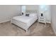 Comfortable bedroom boasts carpeted floors, a queen bed, and white nightstands at 20285 Symphony Pl, Venice, FL 34293