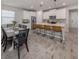 Spacious open-concept kitchen with an island bar that seats four, with a dining area to the left at 20285 Symphony Pl, Venice, FL 34293