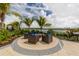 Outdoor patio with comfortable seating, a fire pit, and serene water views for relaxing gatherings at 20285 Symphony Pl, Venice, FL 34293