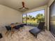 Relaxing screened lanai featuring comfortable seating, dining area, and a ceiling fan at 20285 Symphony Pl, Venice, FL 34293