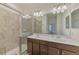 A spacious bathroom with a double sink vanity and glass enclosed shower at 20290 Lagente Cir, Venice, FL 34293